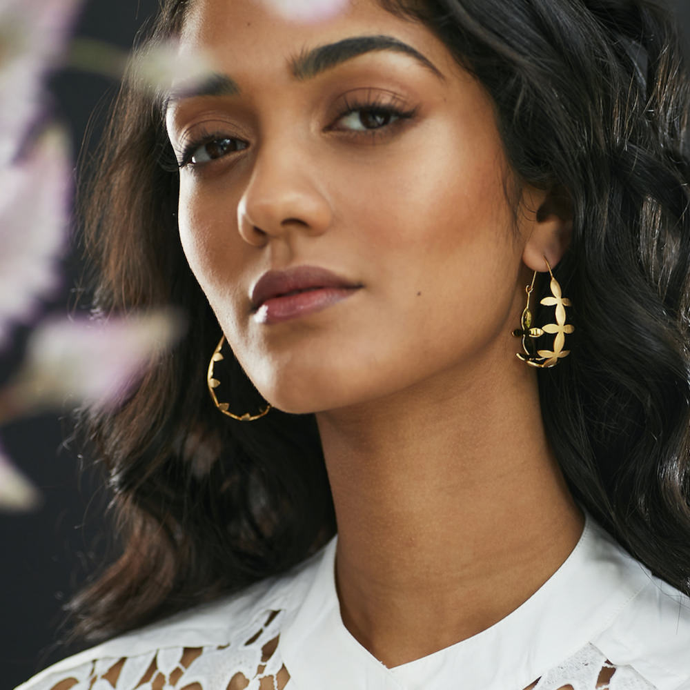 Woman looking at camera with Brave Edith large gold Thanaka teardrop hoop earrings